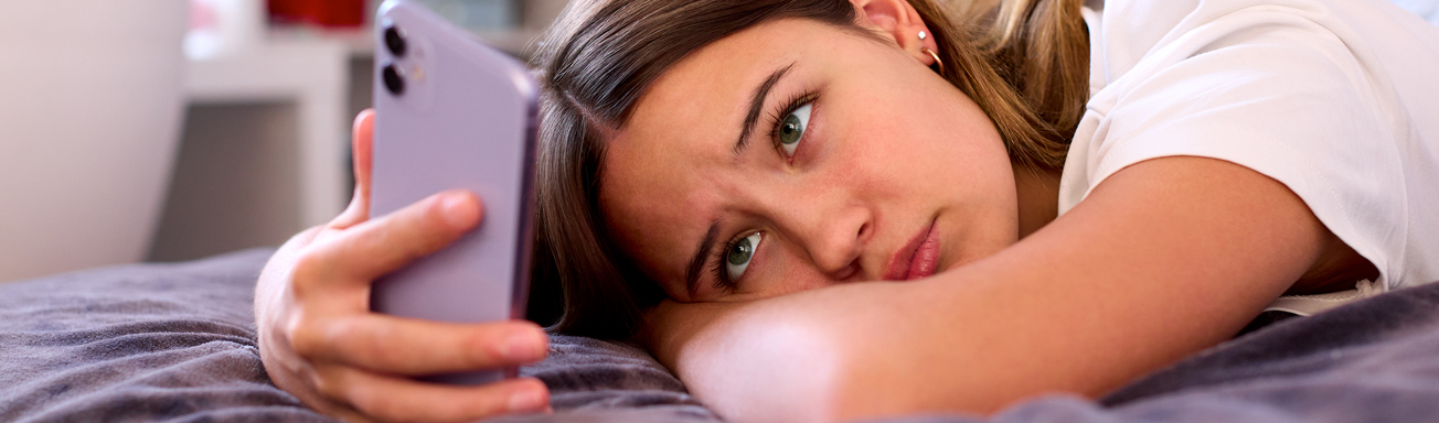 Should you follow your kids on social media__Hero A teen victim of sextortion looking at phone